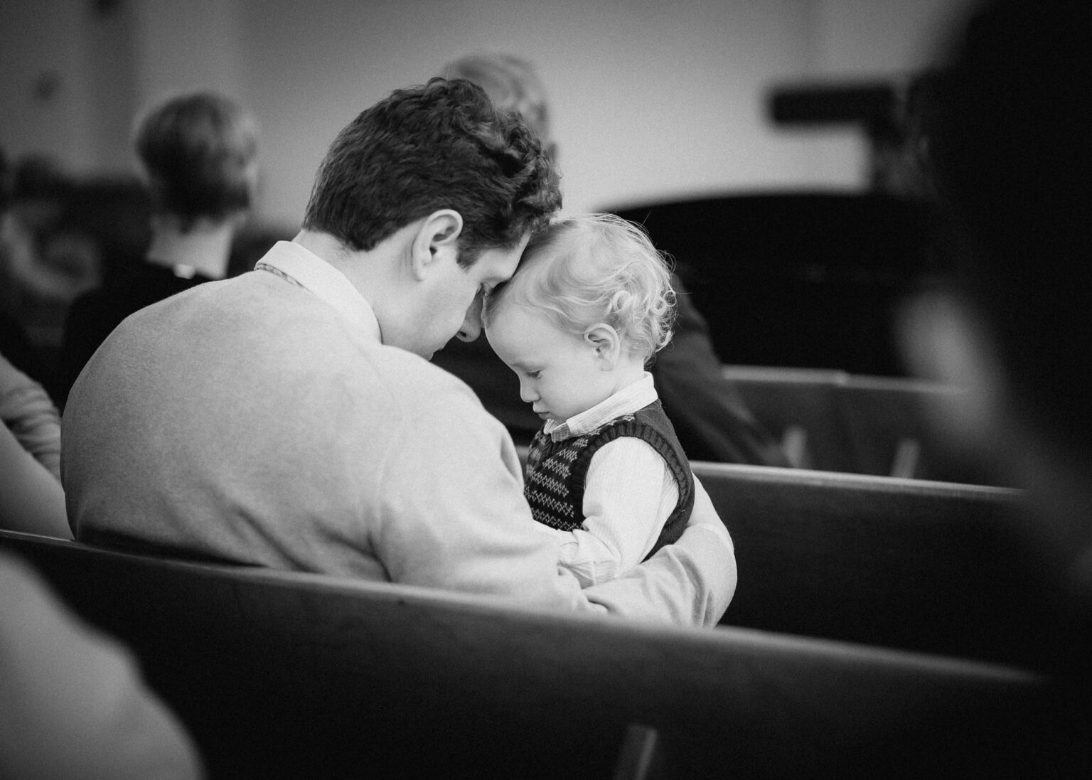 Gäste sitzen in festlich geschmückter Kirche. Hochzeitsreportage Matthias Popp